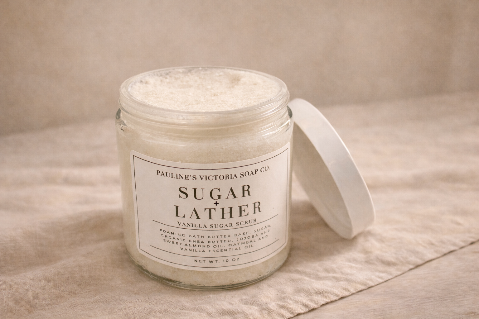 Jar of Pauline Victoria Soap Co. sugar lather on a beige surface