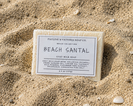 Bar of soap labeled 'Beach Santal' from Pauline's Victoria Soap Co. on a sandy background