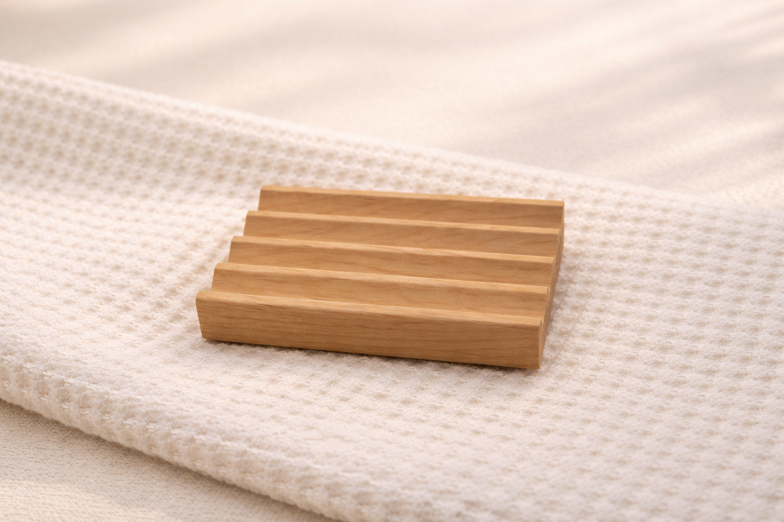 Wooden soap dish on a textured white surface