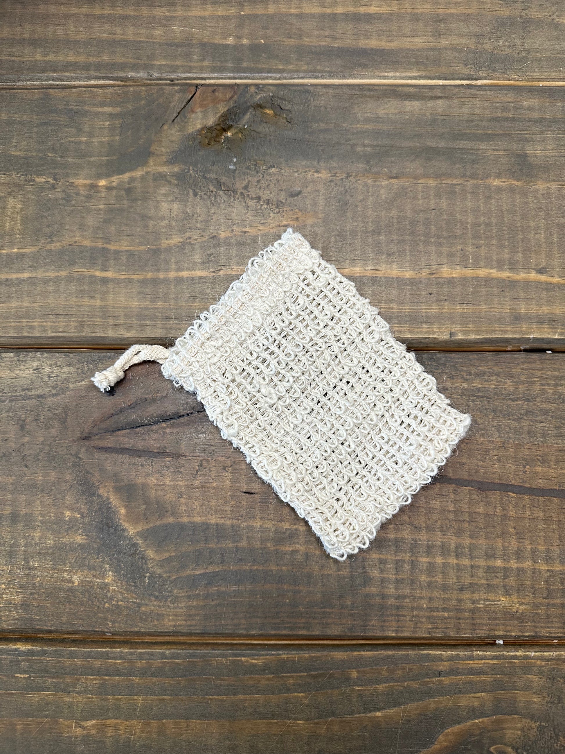 One sisal soap saver sack on a wooden surface